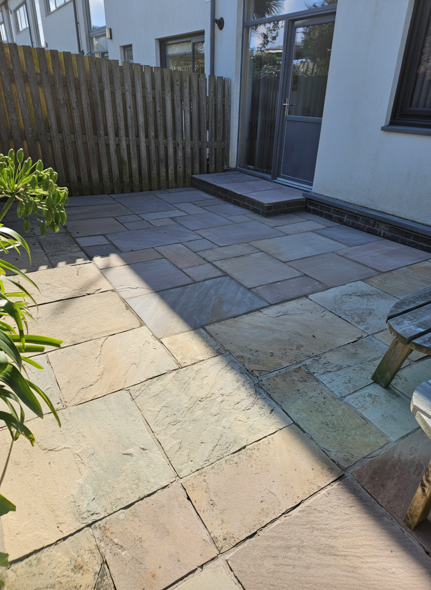 Completed Indian sandstone patio area replacing old decking in Rhosneigr